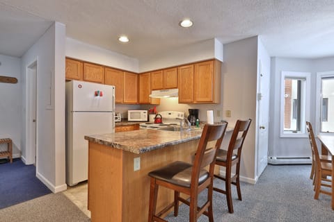 Bright modern Kitchen, open floor plan brings all your social activities together.  Great breakfast bar for two on those early mornings while enjoying your coffee before everyone gets up!