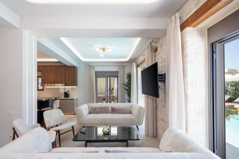 The living room design is both cozy and chic, featuring a combination of comfortable seating and elegant decor.