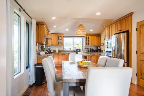 The kitchen and dinning space has it all for your group to share a meal together