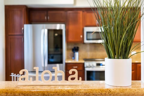- Warm aloha vibes greet you from this golden granite counter overlooking the full kitchen - Stainless steel appliances and wood cabinets offer style and convenience - Touches of greenery bring freshness and a welcoming island spirit