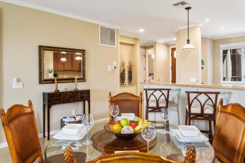 - Warm and welcoming dining nook with a glass top table set for four - Decorative bowl of fruit and classic wooden chairs add charm and hospitality - Conveniently located near the kitchen and open to the living space