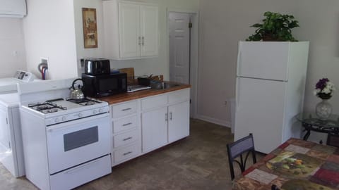 Kitchen equipped with stove, microwave, toaster, coffee-maker, pots & pans, etc.