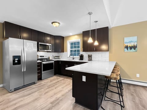 Fully equipped kitchen with breakfast bar and seating.