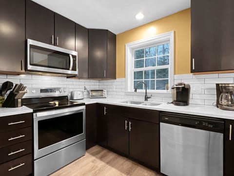 View of the sink, electric range, and dishwasher.