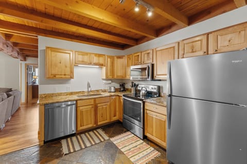 Updated full size kitchen with granite countertops and stainless steel appliances.