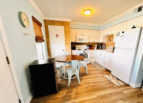 The dining table seats 4 and the kitchen comes complete with microwave, oven, refrigerator, toaster oven, air fryer and Keurig coffee maker