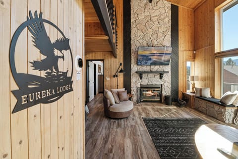 Welcome To Eureka Lodge! The Living Room Features A Two-story Vaulted Ceiling And, A Floor-to-ceiling Stone Fireplace.