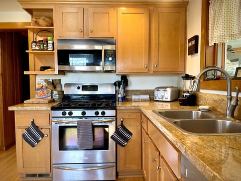 Convection oven and microwave on top, 5 burner stove and oven below, toaster.