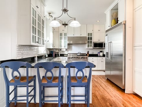 The beautifully detailed full kitchen has everything you need to make your own meals, including modern appliances, place settings, pots and pans, and wine glasses at Mill Haus.