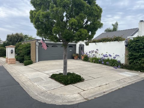 Home located on corner of 2 streets with attached garage and courtyard entrance.