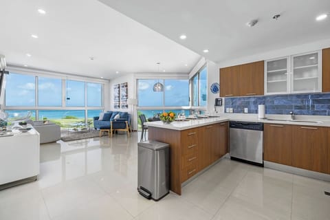 Your oceanfront retreat blends modern comfort with stunning sea views. The open-concept kitchen flows into a bright living space where turquoise waters and coastal breezes become part of everyday life.
