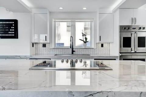 3rd FLOOR: KITCHEN. 30 foot island. Viking appliances (double oven, warmer, full fridge, wine fridge, dishwasher, drawer microwave, 6 burner cooktop with retractable vent, dishwasher), built-in Miele espresso machine. 48 inch sink. 