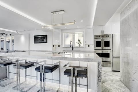 3rd FLOOR: KITCHEN. 30 foot island. Viking appliances (double oven, warmer, full fridge, wine fridge, dishwasher, drawer microwave, 6 burner cooktop with retractable vent, dishwasher), built-in Miele espresso machine. 48 inch sink. 