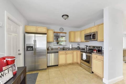 Kitchen with stainless steel appliances and coffee station. 