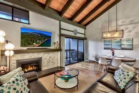 Inviting open concept family room with modern fireplace, flat screen TV and board games (1)