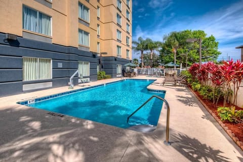 Dive into the sparkling outdoor pool under sunny skies.