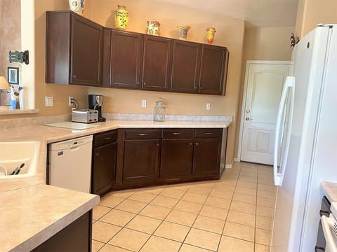Kitchen showing door to garage at far end