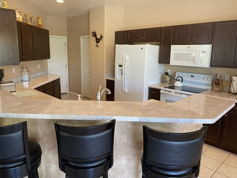 Kitchen with bar and five bar stools