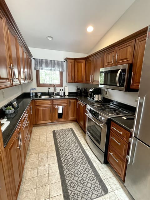 Main Cottage fully stocked kitchen Oven dishwasher stainless granite countertops. Toaster electric skillet servewear ice cube trays