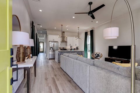 Let's take a tour of Miro Maison! Walk into the open living room/kitchen. With ample seating and a large TV, you'll find it hard to get up off this lovely sofa!