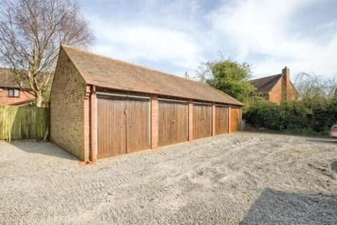 Private garages to the rear driveway and designated parking opposite.