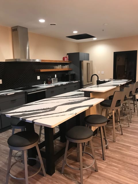 Kitchen island with Cambria counter top has seating for10