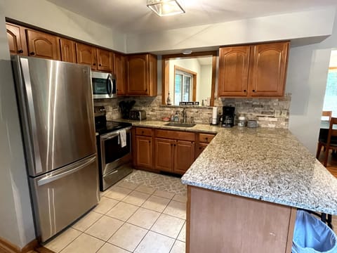 Kitchen with Stainless Steel Appliances and Window Passthrough.