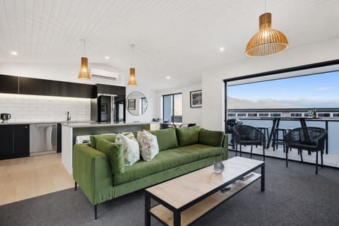 Relax in the bright open plan living space, featuring a fully equipped kitchen, 