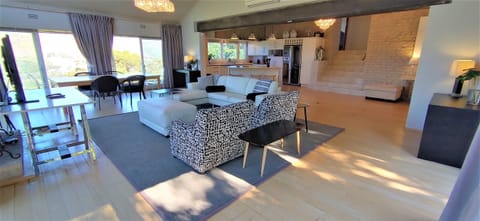 The living area has a large dining table that can seat up to 6 persons