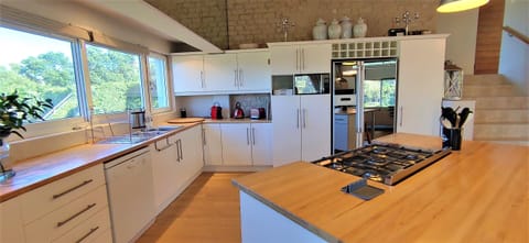 The kitchen counters are Rhodesian oak wood, giving a warm feeling to the area