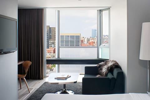 Settle into the sofa beside bright windows and soft textures.