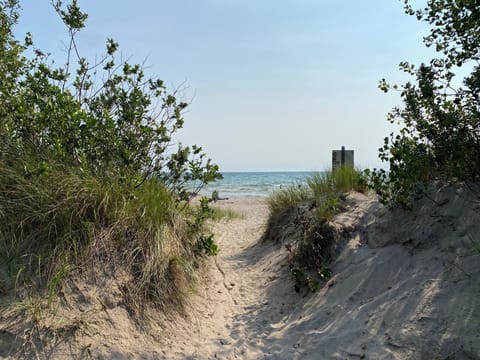 Beach across the water accessible by canoe, kayaks or boat.