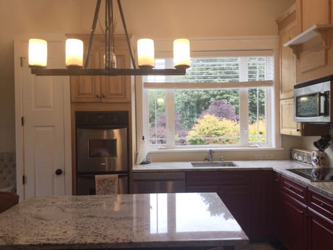 Carriage house kitchen equipped with
double oven, dishwasher and refrigerator