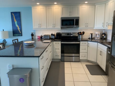 Gourmet granite kitchen with all the utensils needed.