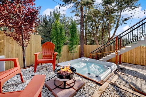 Private outdoor hot tub, surrounded by tall pines, perfect for relaxing under the trees after a day of adventure—enjoy peaceful forest views, fresh air, and a truly rejuvenating stay.