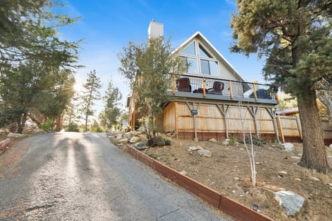 Welcoming cabin entry surrounded by towering pine trees, offering fresh mountain air and a peaceful forest setting—the perfect first impression for your Big Bear Lake getaway.