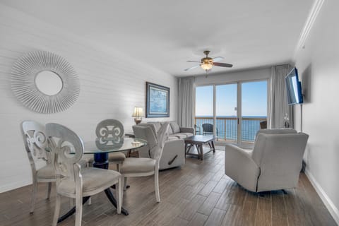 Living Room - Luxury and comfort meet in this beachfront living room with plush seating, a large flat-screen TV, and stunning ocean views through floor-to-ceiling windows.