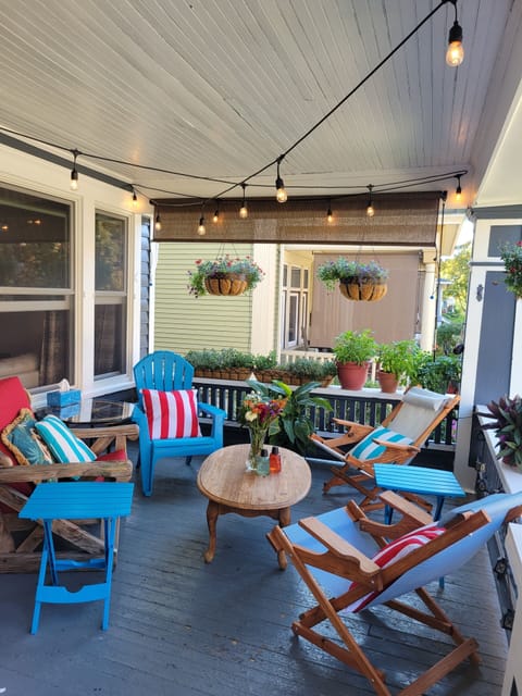 Relaxing front porch that's perfect for happy hour sips to watch the sun set