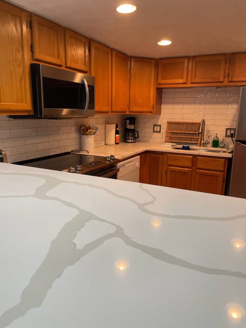 All new appliances, quartz countertops and tile in the fully stocked kitchen.
