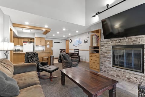 Unwind in your spacious open-concept retreat where the warm stone fireplace creates the perfect ambiance for cozy evenings, while the fully equipped kitchen and comfortable seating invite you to feel completely at home.