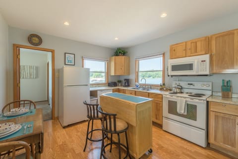 Full kitchen with dining area. Far door leads to main bedroom.