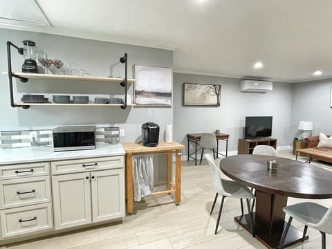 Open kitchen design with dining area in view — perfect for meal prep or takeout.