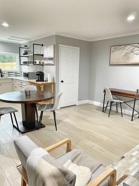 Crisp kitchen view showing layout and entry to the bathroom.