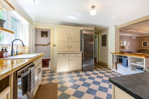 Kitchen showing private staircase leading to primary bedroom.