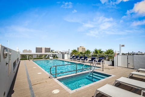 Rooftop pool and jacuzzi with lounge chairs at Bay Harbor Islands vacation rental near Bal Harbor Shops and Surfside Beach, perfect for family-friendly Miami getaways