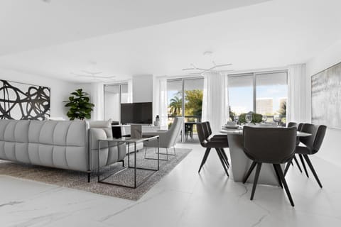 Spacious modern living room with Smart TV, dining area, and balcony at Bay Harbor Islands vacation rental near Miami Beach and Bal Harbor Shops