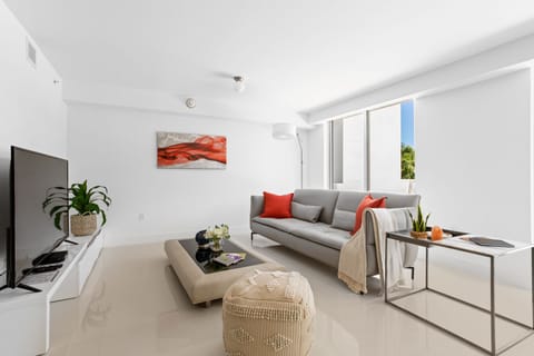 Spacious modern living room with Smart TV, dining area, and balcony at Bay Harbor Islands vacation rental near Miami Beach and Bal Harbor Shops