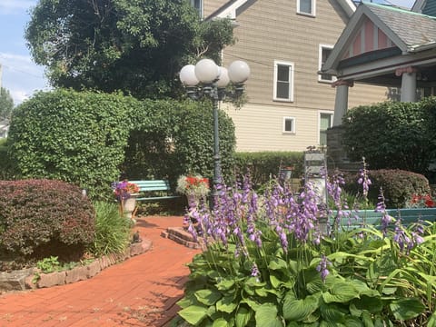 Victorian Garden in front of the house with benches. 