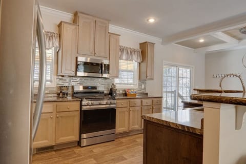 Large open kitchen has a gas range, full size refrigerator, microwave, dishwasher, coffee machine, toaster, and all pots/pans for cooking up a feast.