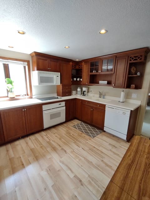 Kitchen fully stocked with dishes and cooking utensils